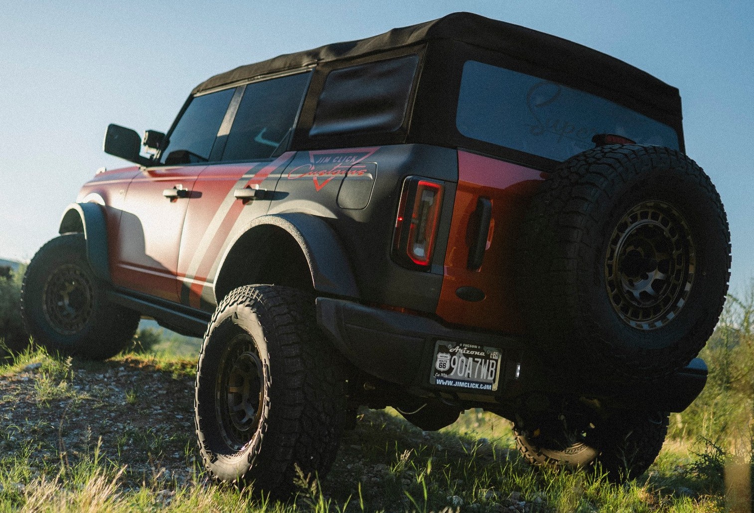 rear view of red ford bronco on off-road trail