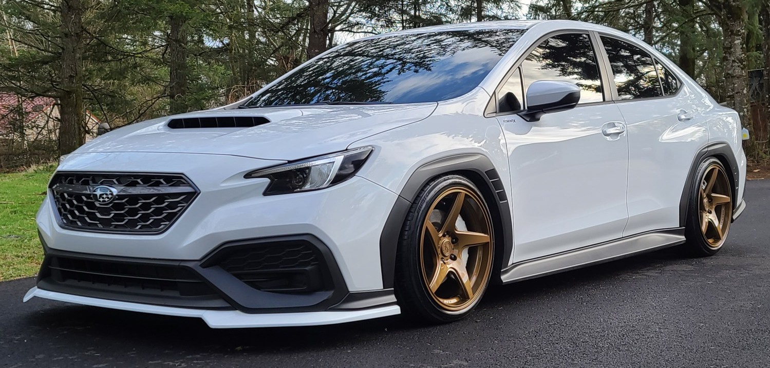 bronze anovia wheels on white subaru