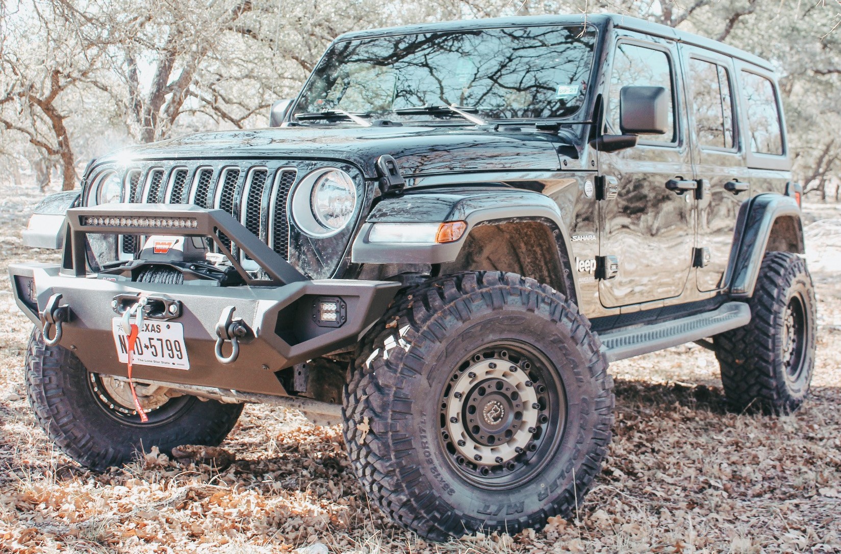 front view of black jeep wrangler on trail