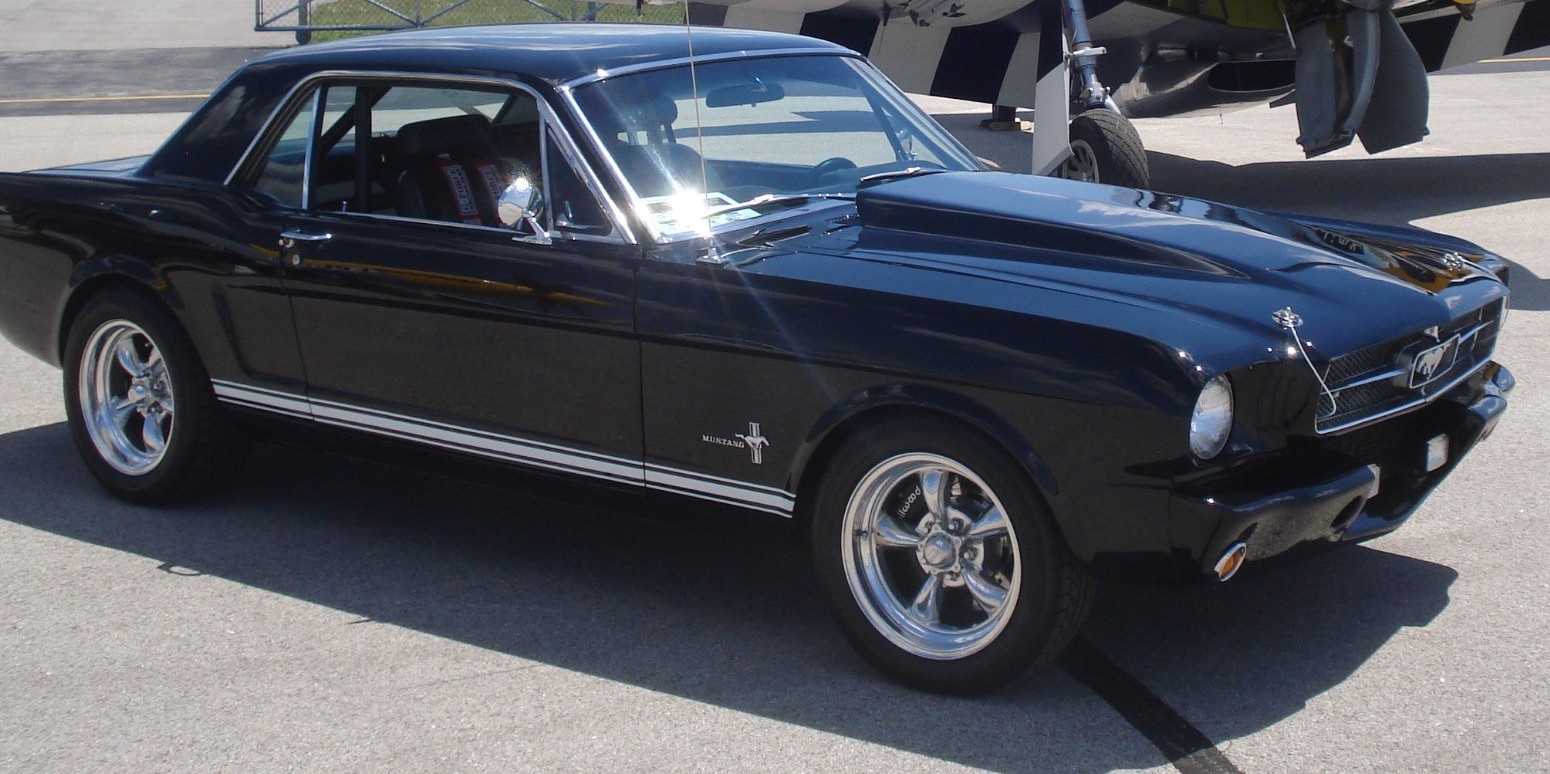 profile view of black first-gen mustang