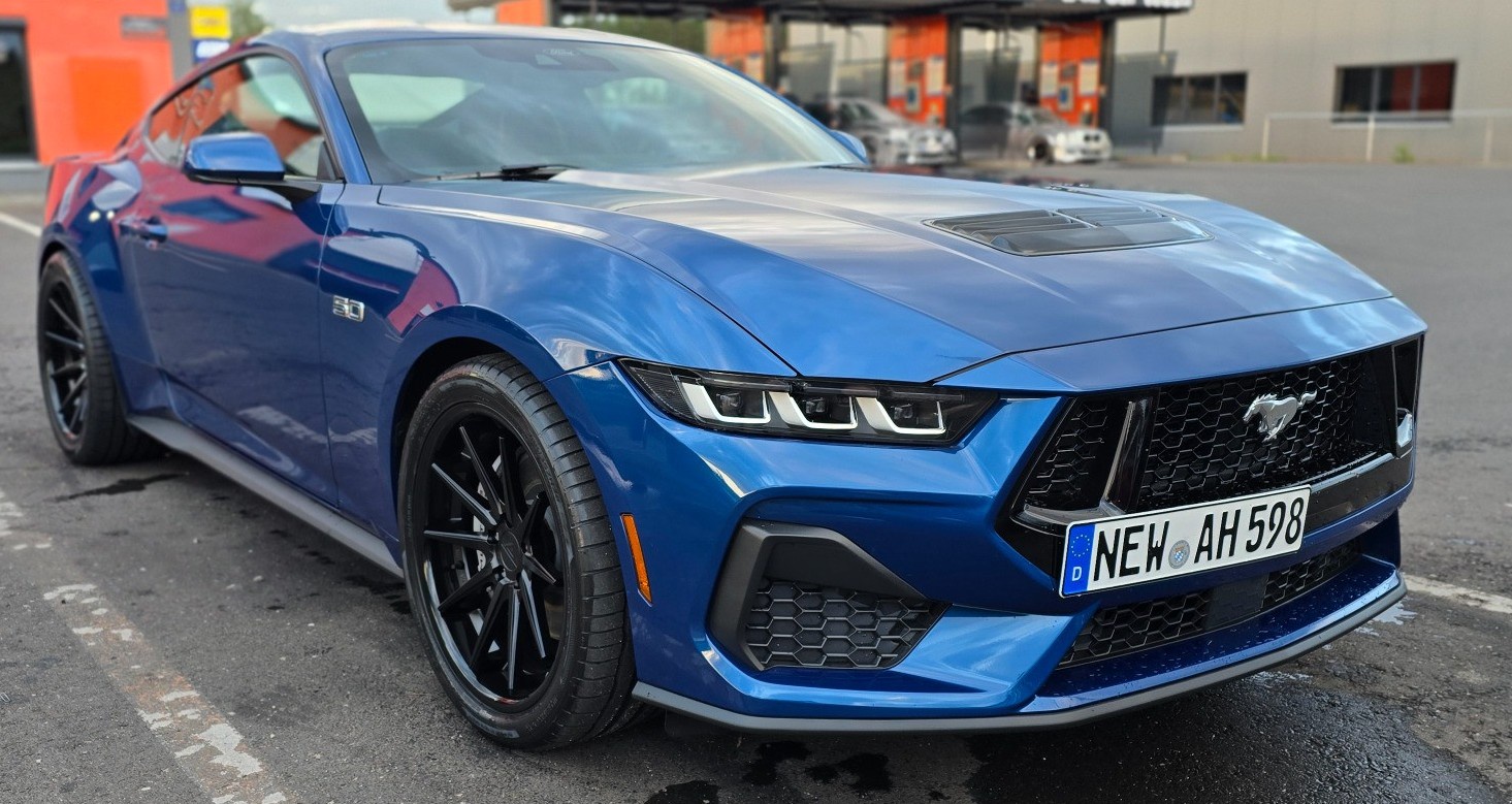 blue ford mustang in parking lot