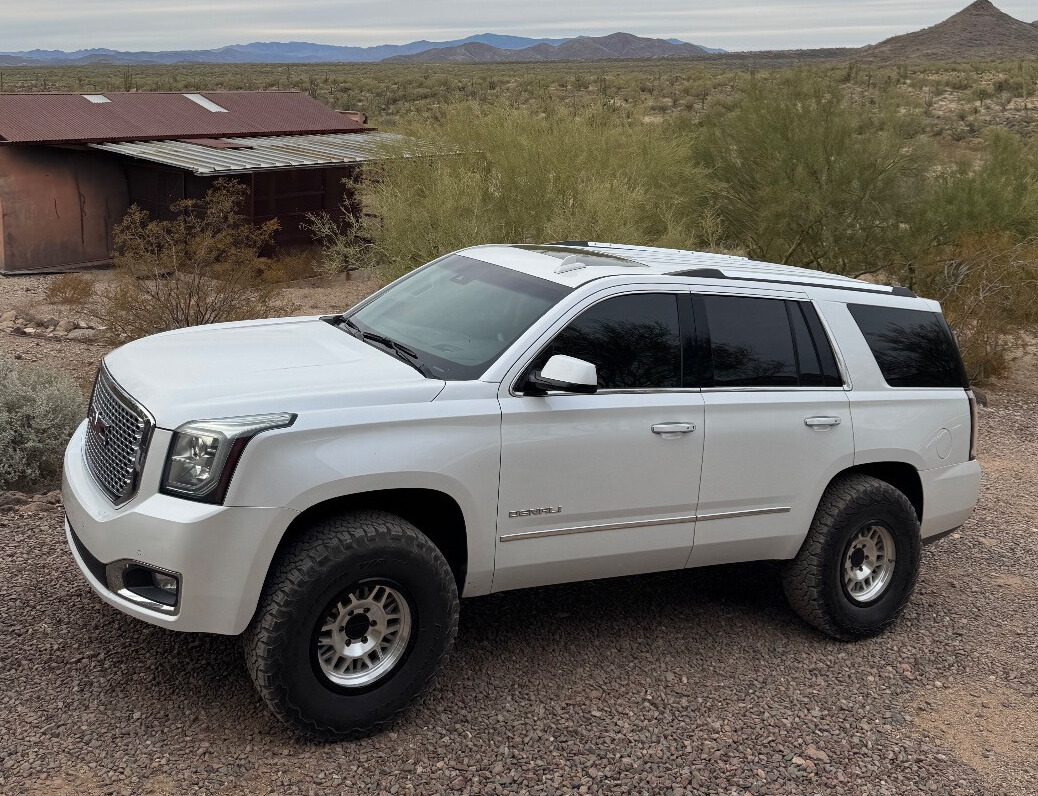 2016 GMC Yukon Denali with Raceline Ryno wheels and Rough Country Suspension Lift
