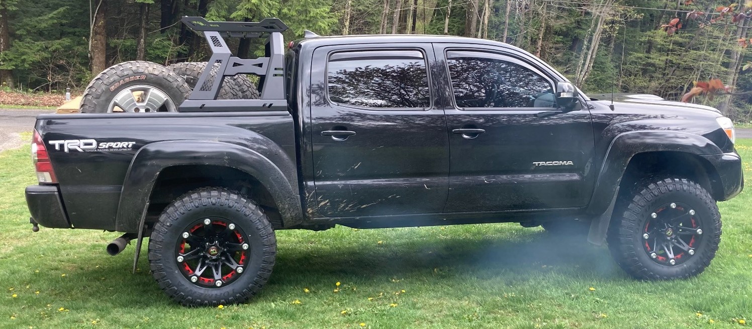 profile view of black toyota tacoma