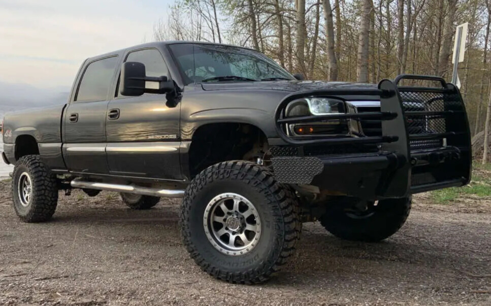 2007 GMC Sierra 2500 with Raceline Avenger wheels and Cooper Discoverer STT Pro tires