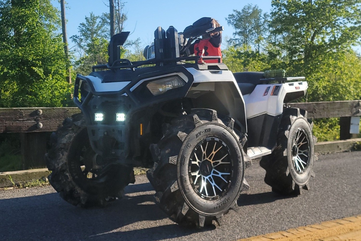 Front view of Polaris Sportsman on trail
