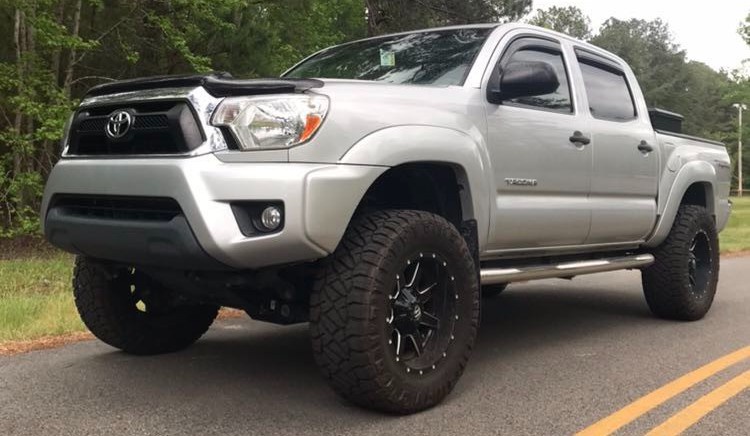 front view of silver tacoma on road