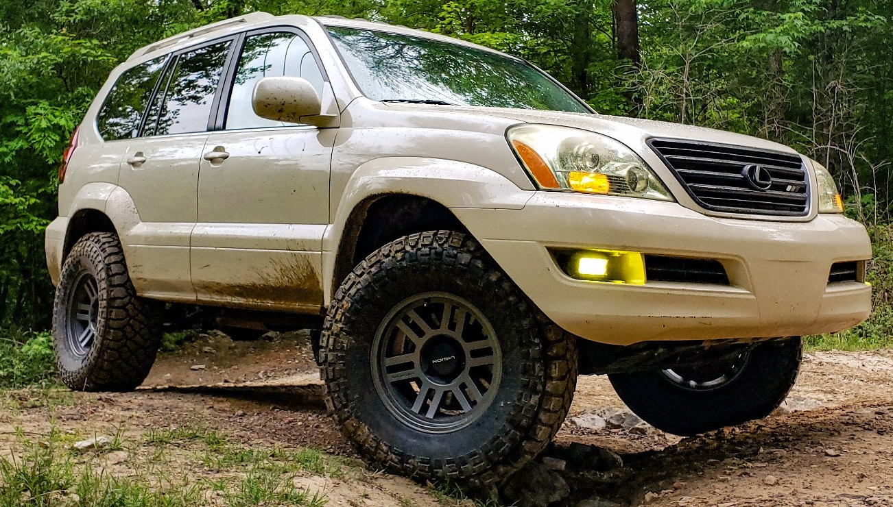 front view of tan lexus gx470 on trail