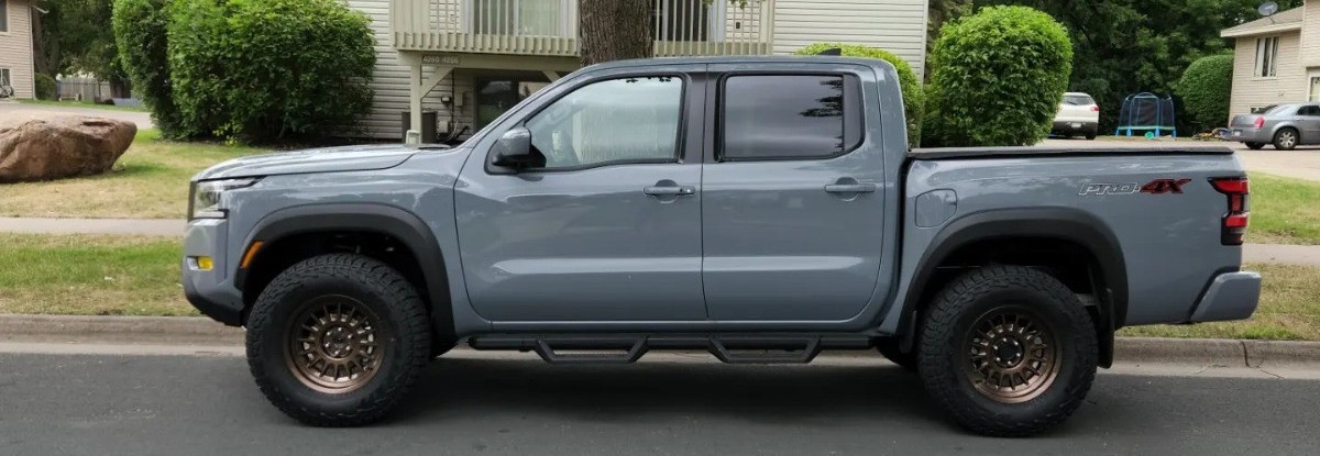 profile view of gray nissan pro 4x with bronze wheels