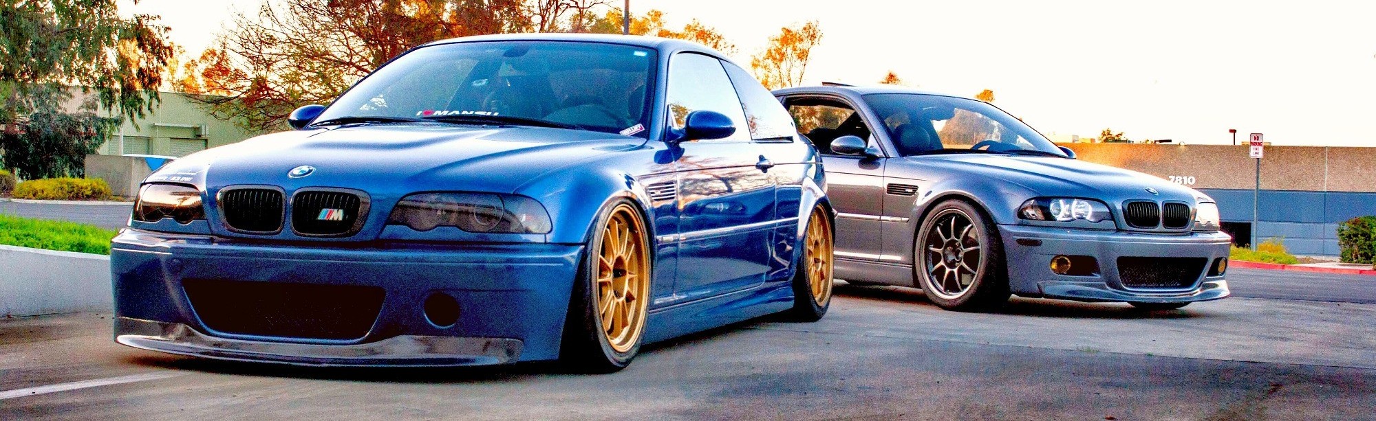 two bmw m3 models in parking lot