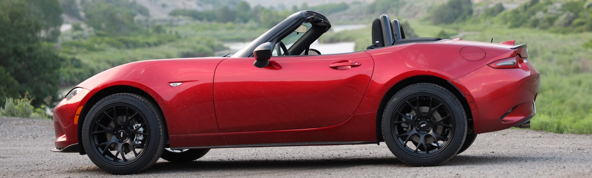 profile view of red miata