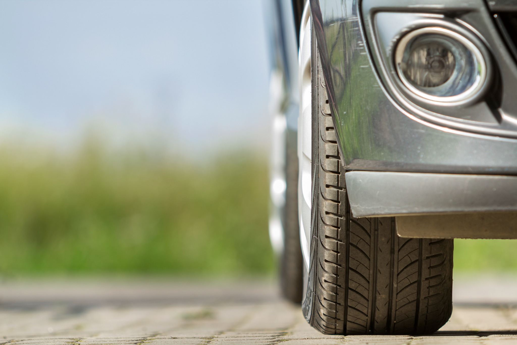 Closeup of car tire on summer road