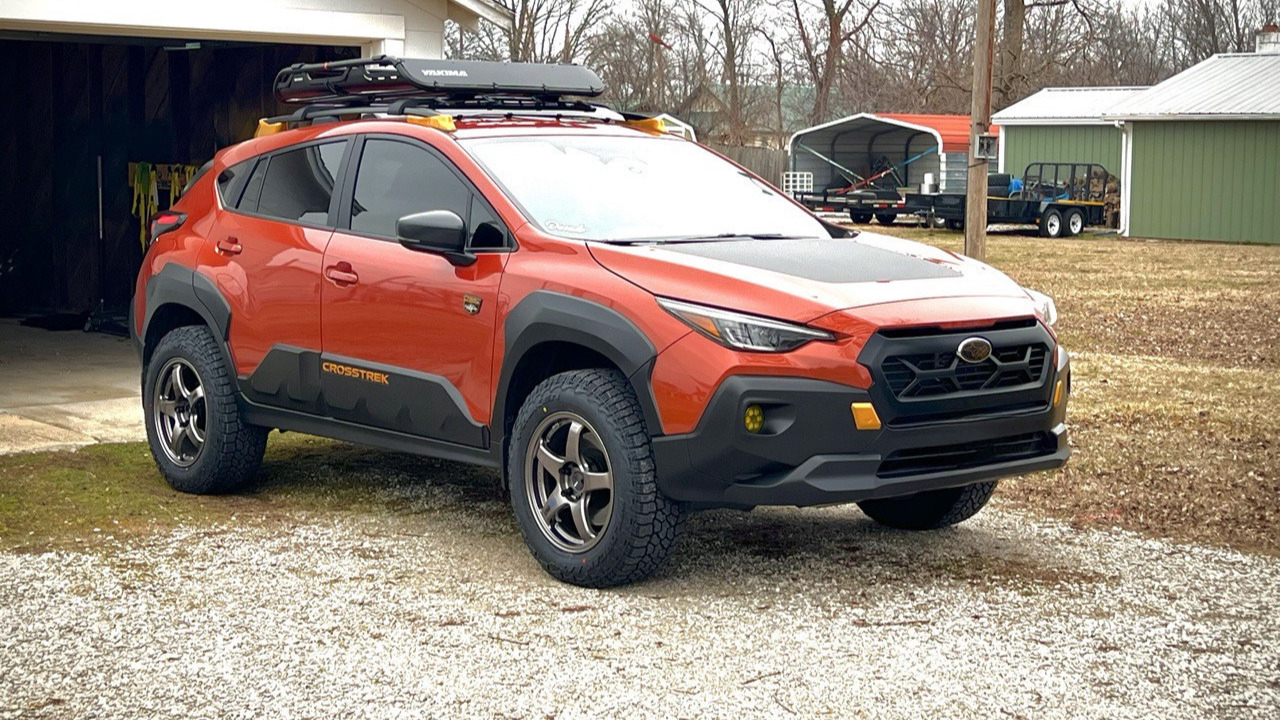 orange subaru crosstrek parked in driveway