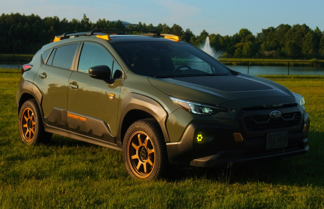 green Subaru Crosstrek with aftermarket wheels and tires 