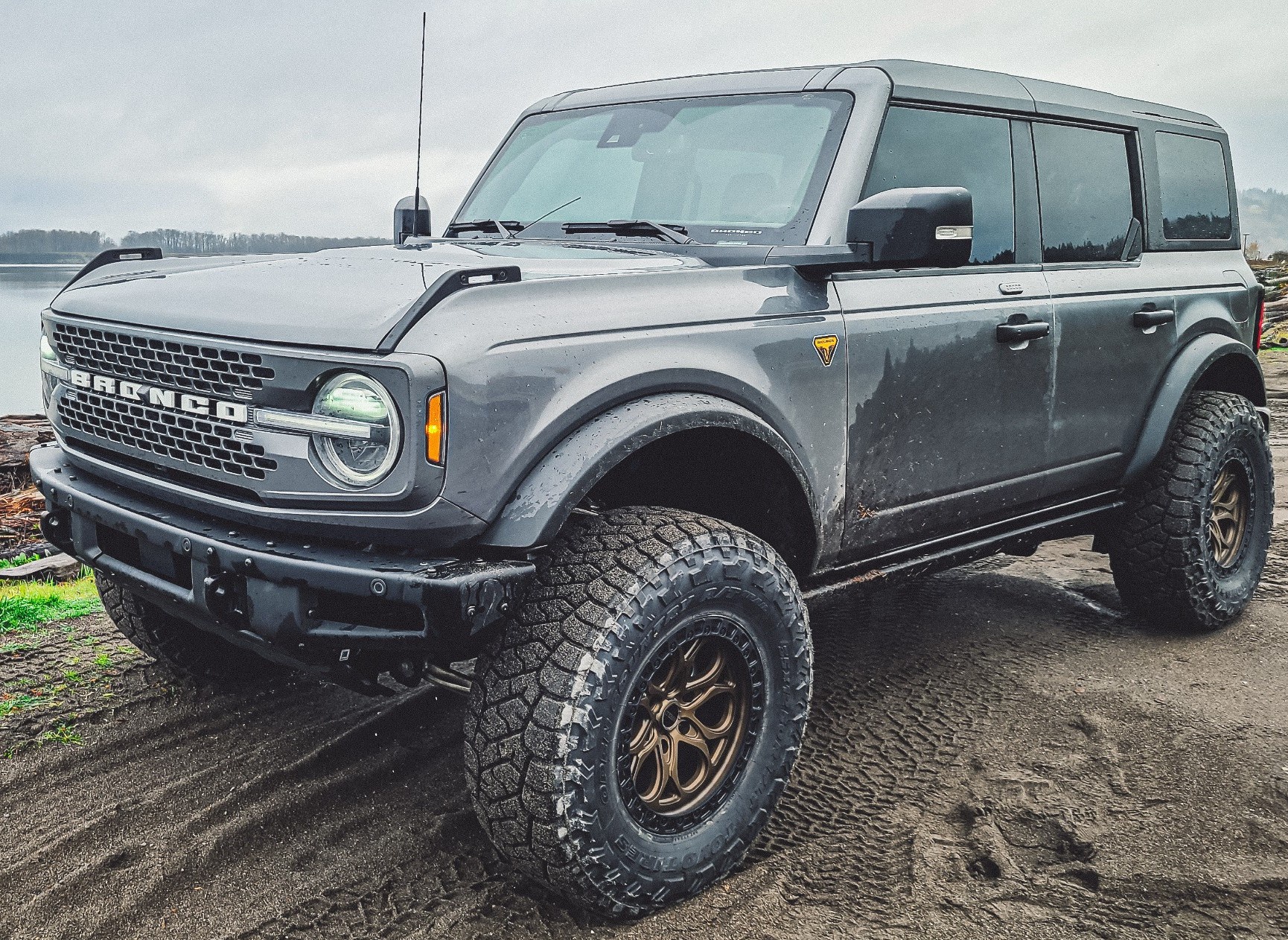 ford bronco driving through mud