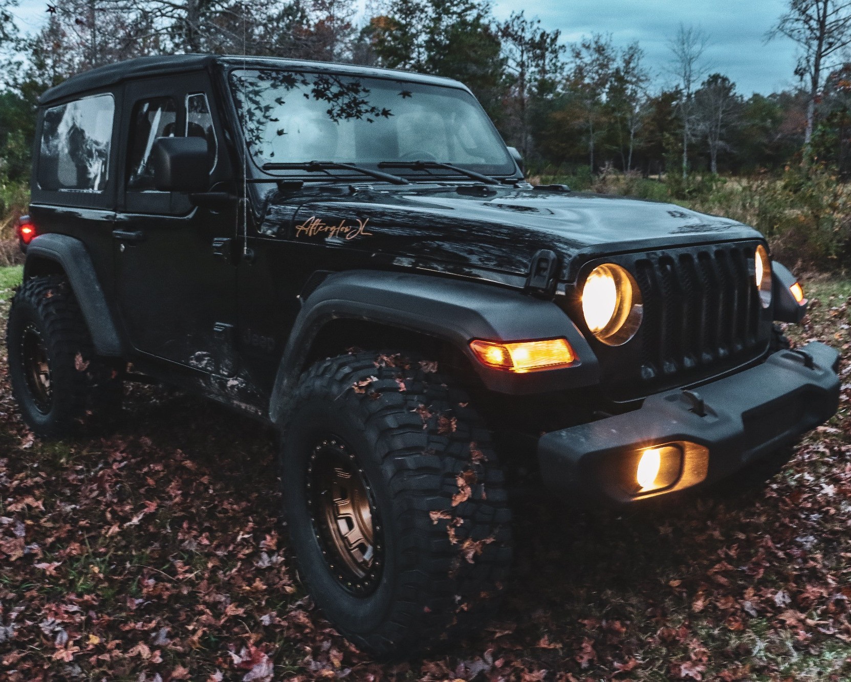 black jeep wrangler on autumn trail
