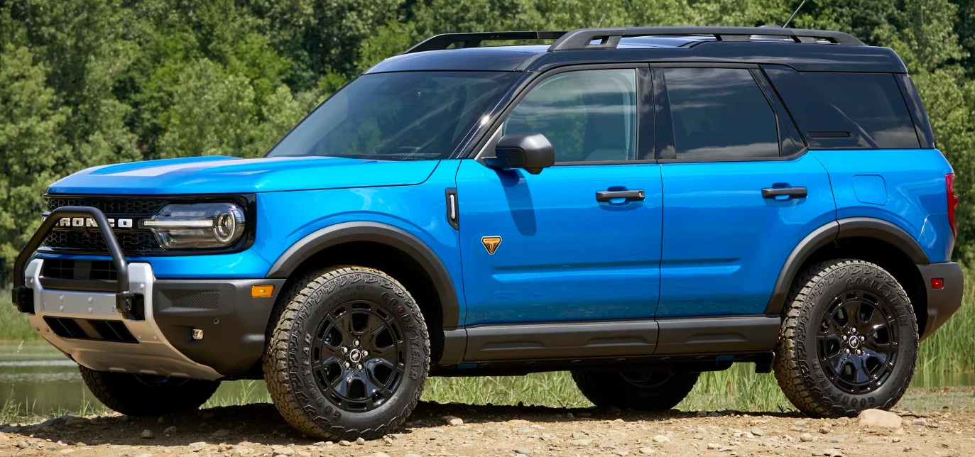 profile view of blue ford bronco sport in front of water