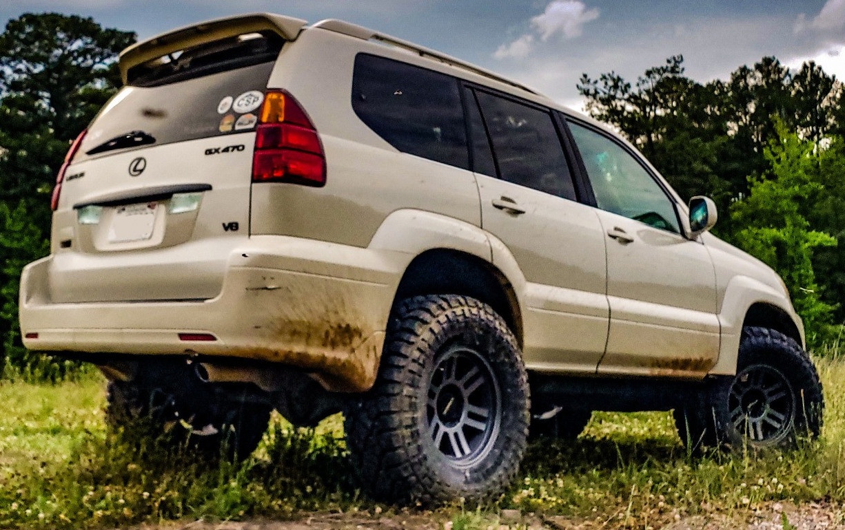 rear view of tan lexus gx470 on trail