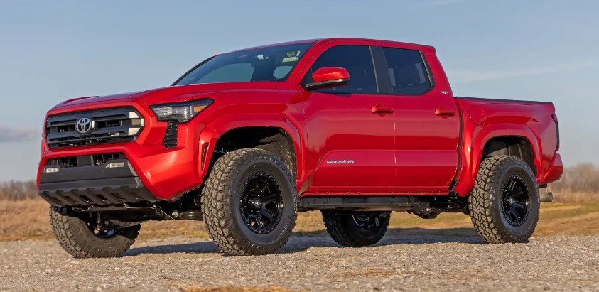 profile view of red toyota tacoma