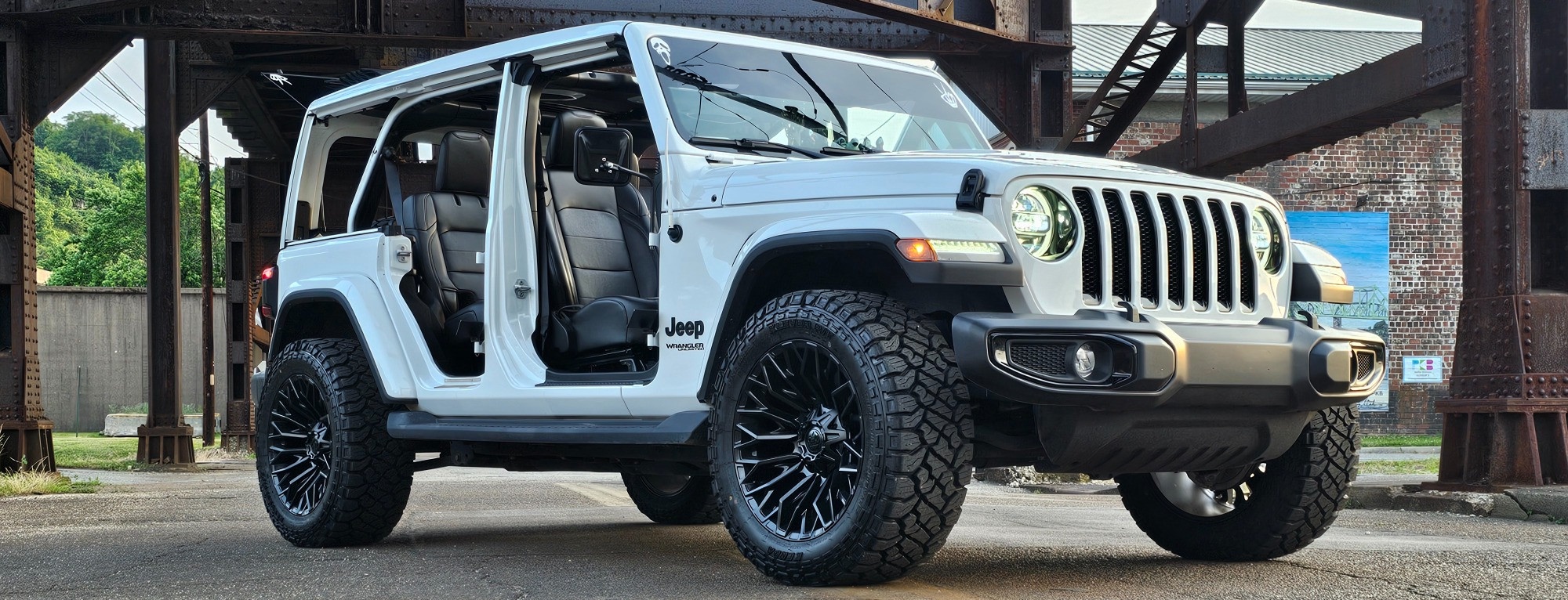 profile view of white jeep wrangler