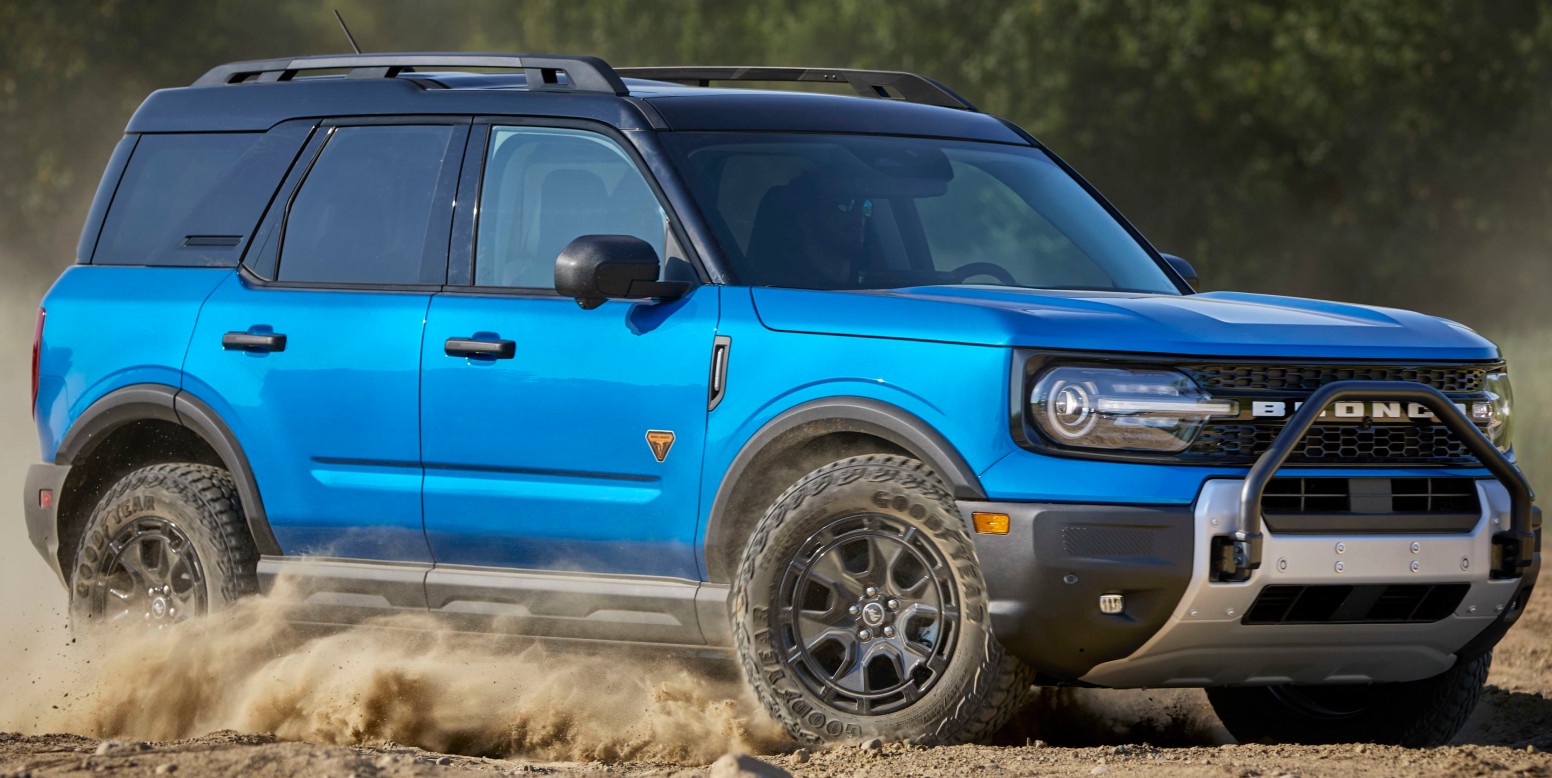 profile view of blue ford bronco sport sasquatch driving through dust