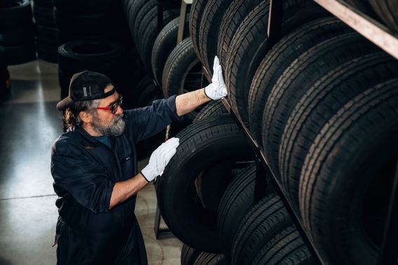 Technician pulling tire from the rack
