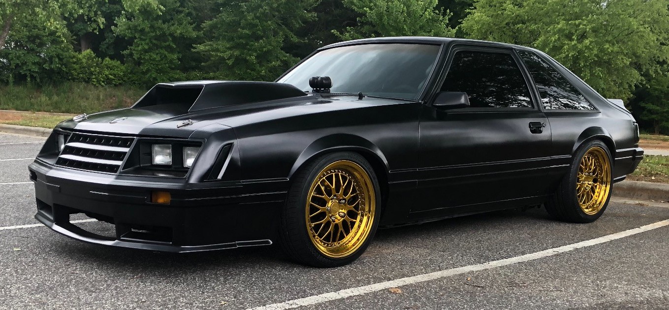 black ford mustang in parking lot