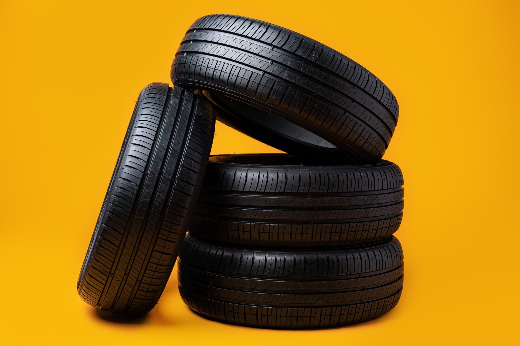 Four tires on a yellow background