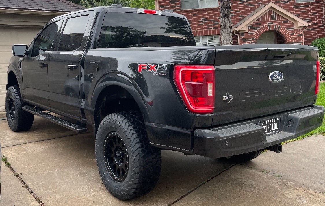 rear shot of ford f-150 with amp terrain attack tires