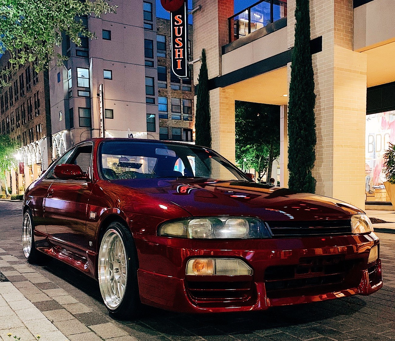 nissan skyline in front of sushi store