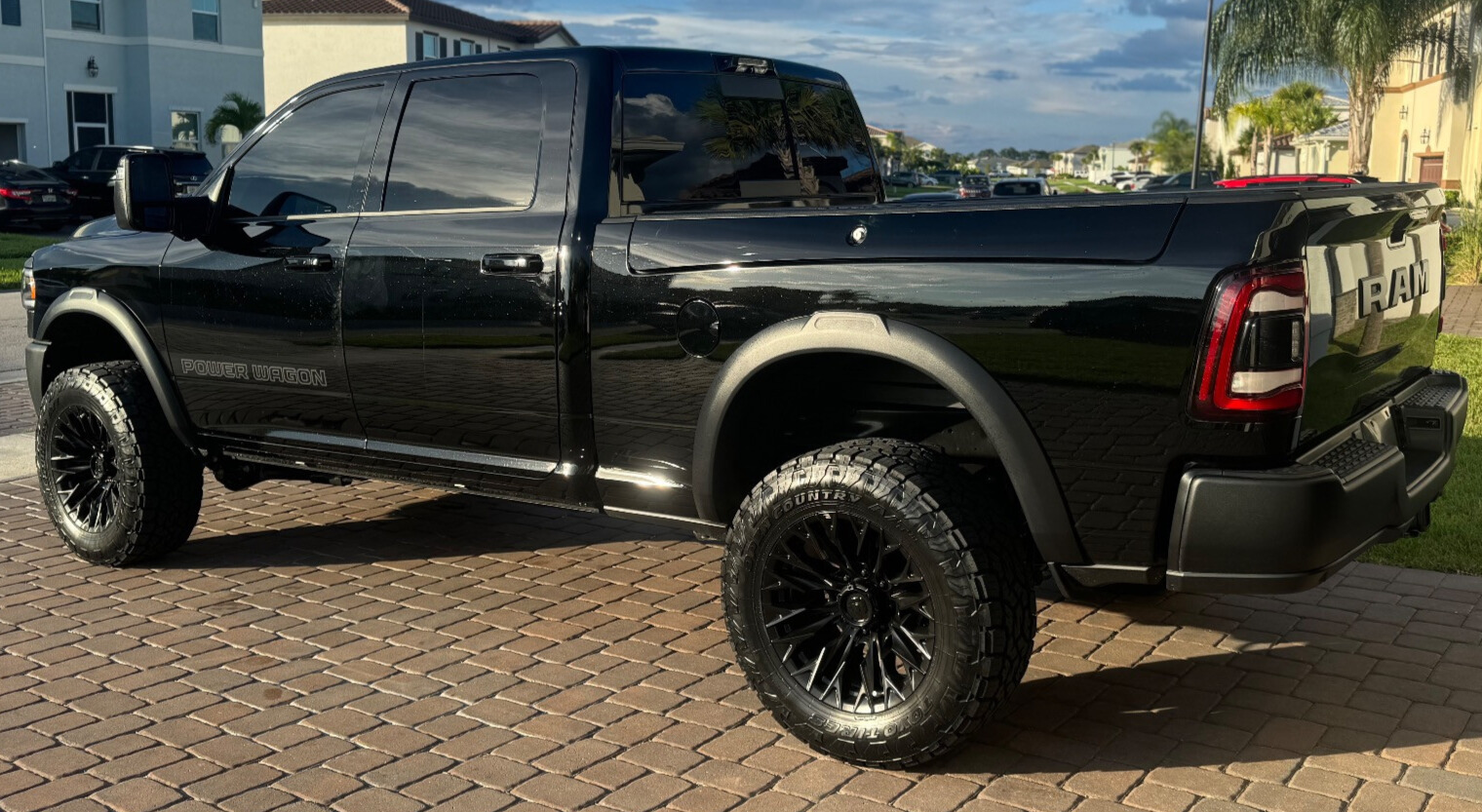 profile view of black truck with toyo open country at 3