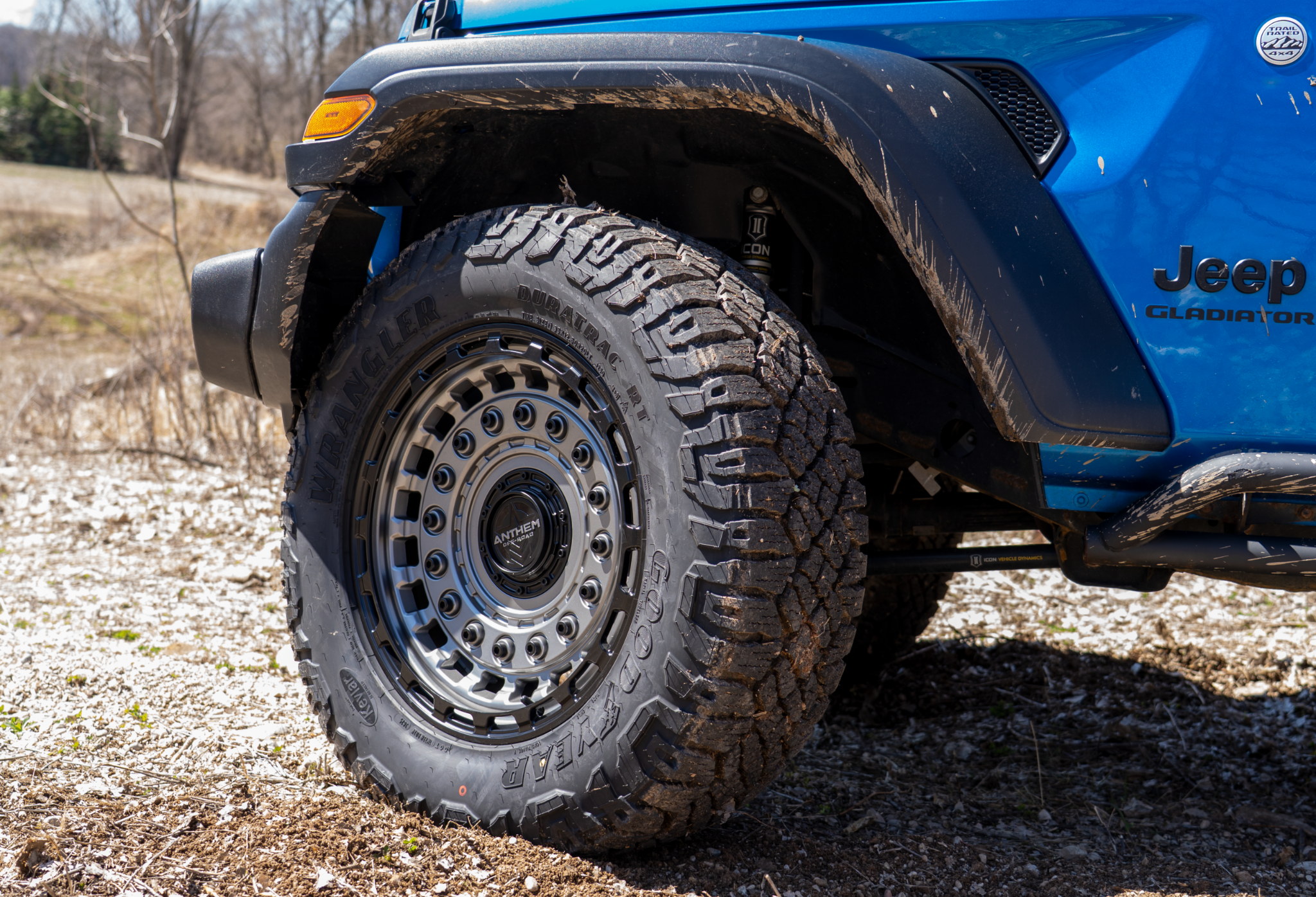 Anthem Off-Road Mercenary wheel on blue Jeep Gladiator parked outisde