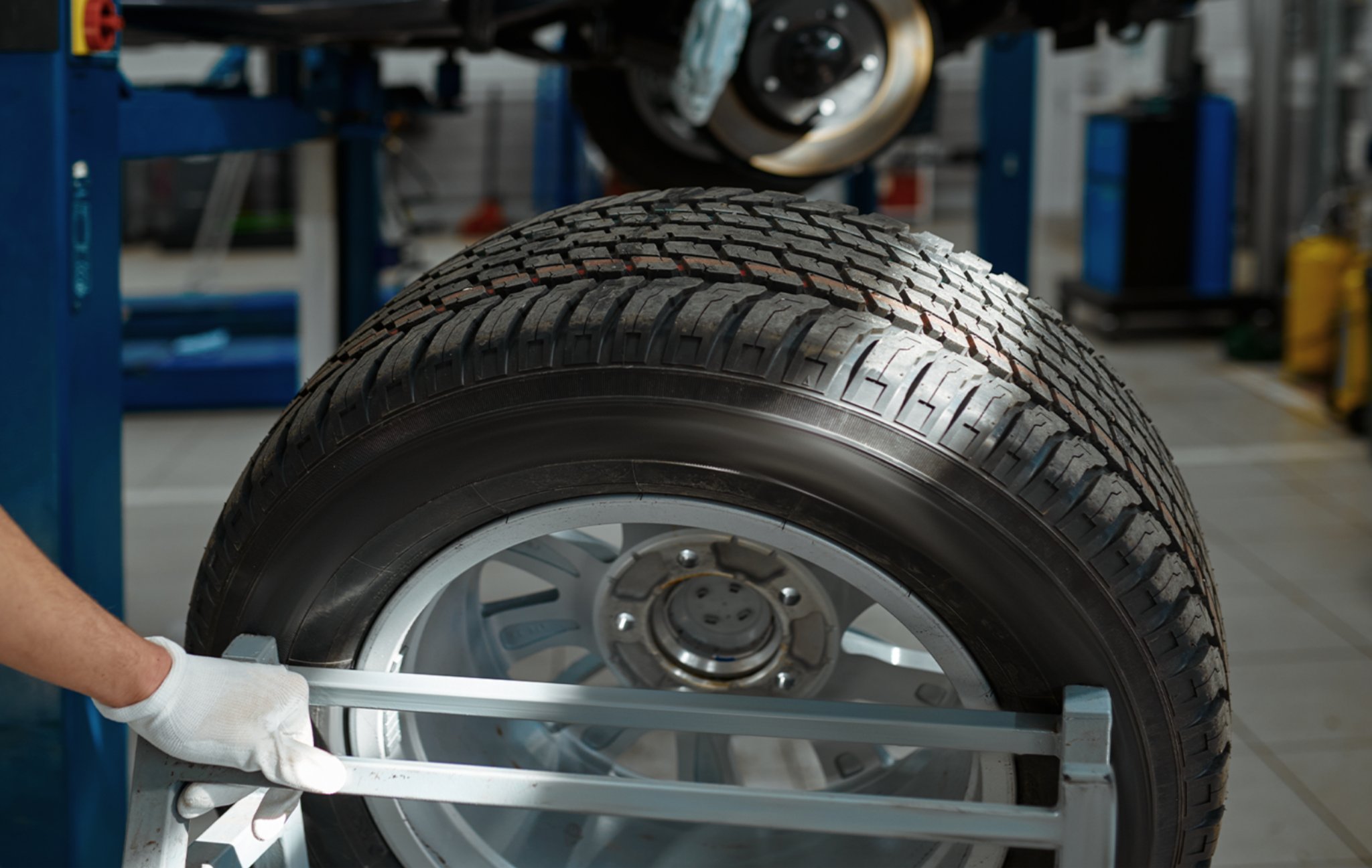 technician checking a tire on a balancing machine