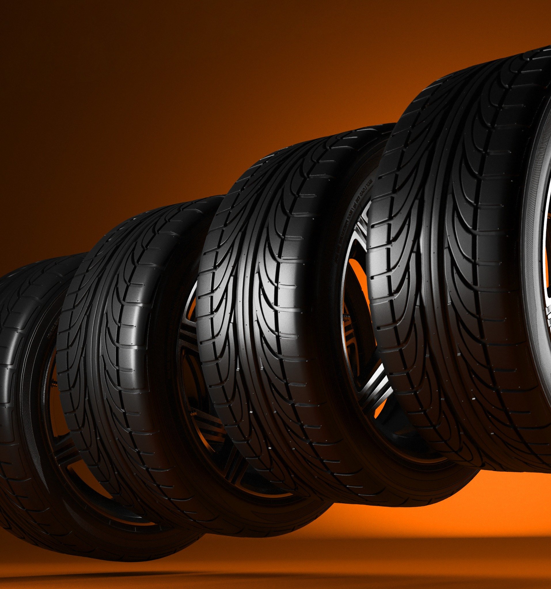 row of performance Hankook tires against an orange background