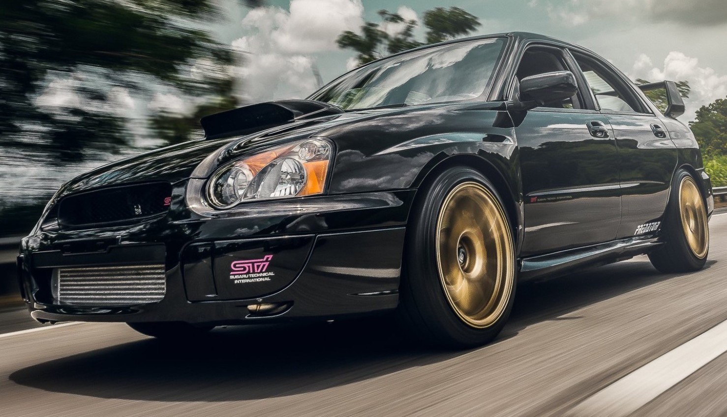 front view of blobeye subaru wrx sti driving on road