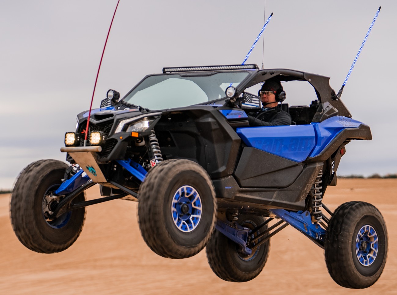 front view of can am maverick driving in sand