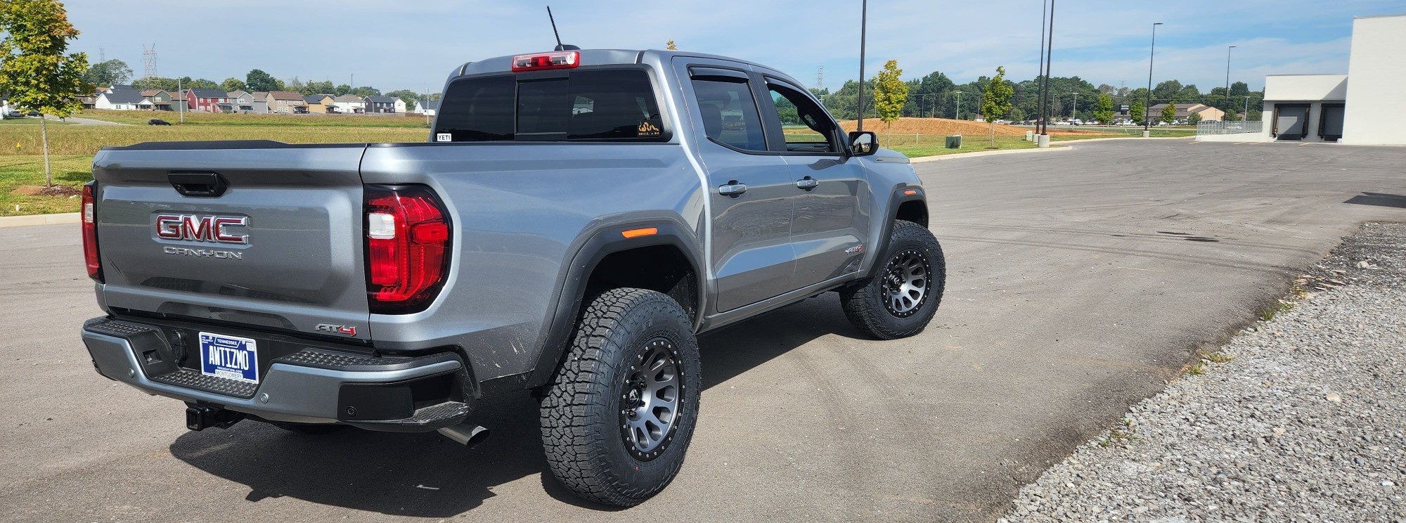rear view of silver gmc canyon on street