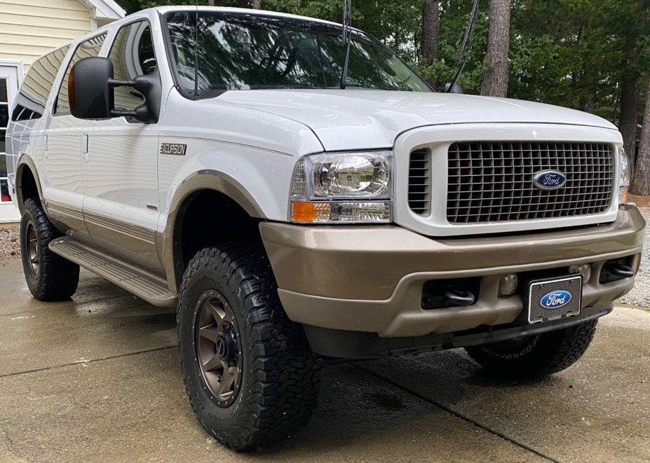 front view of white lifted ford excursion