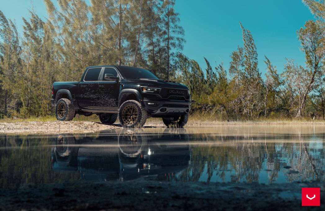 Lifted 5th gen Ram 1500 with aggressive wheel and tire fitment, 3/4 front view