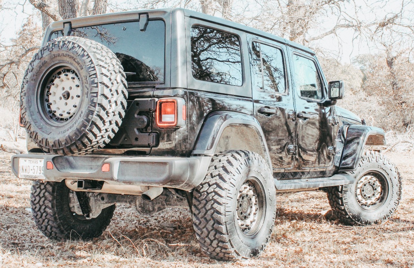 rear shot of black jeep wrangler on trail