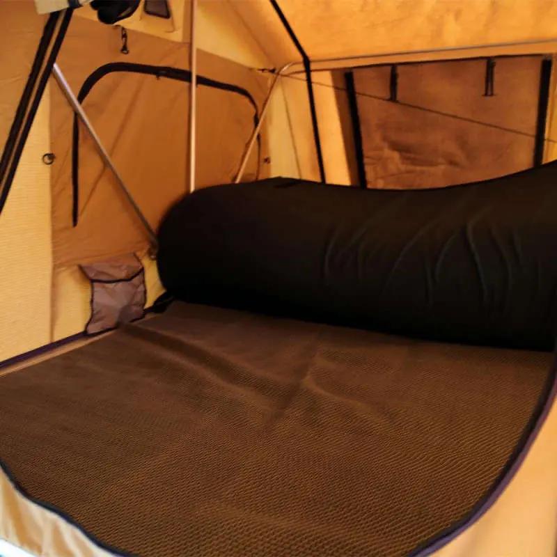 bed inside of rooftop tent