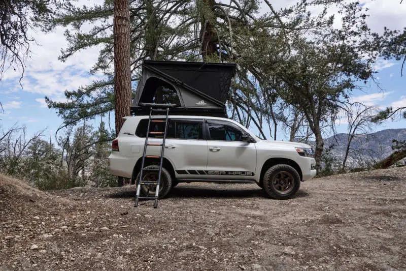 rooftop tent on vehicle under tree