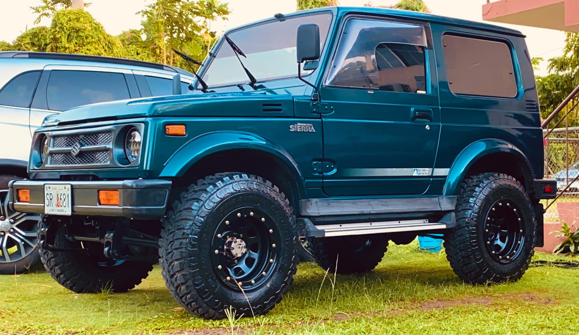 profile view of blue suzuki samurai