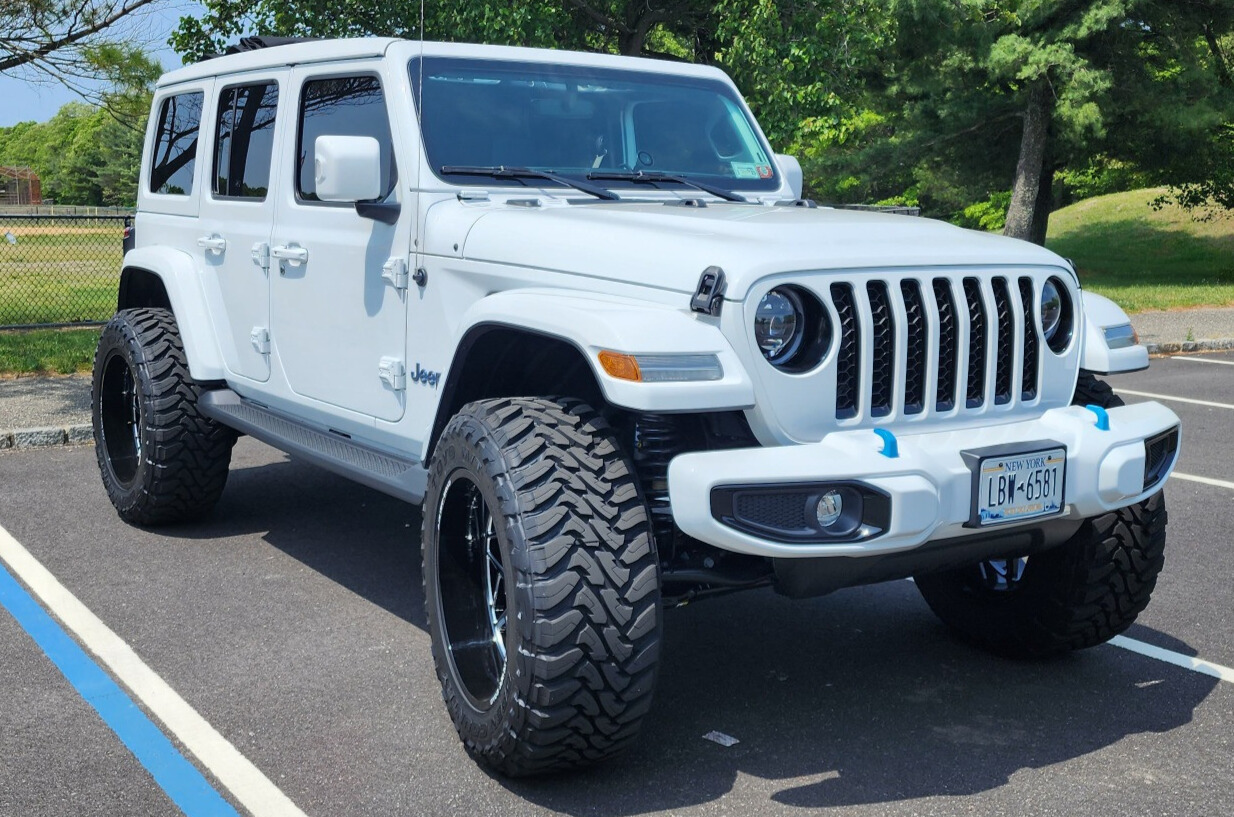 front view of white jeep wrangler in parking lot