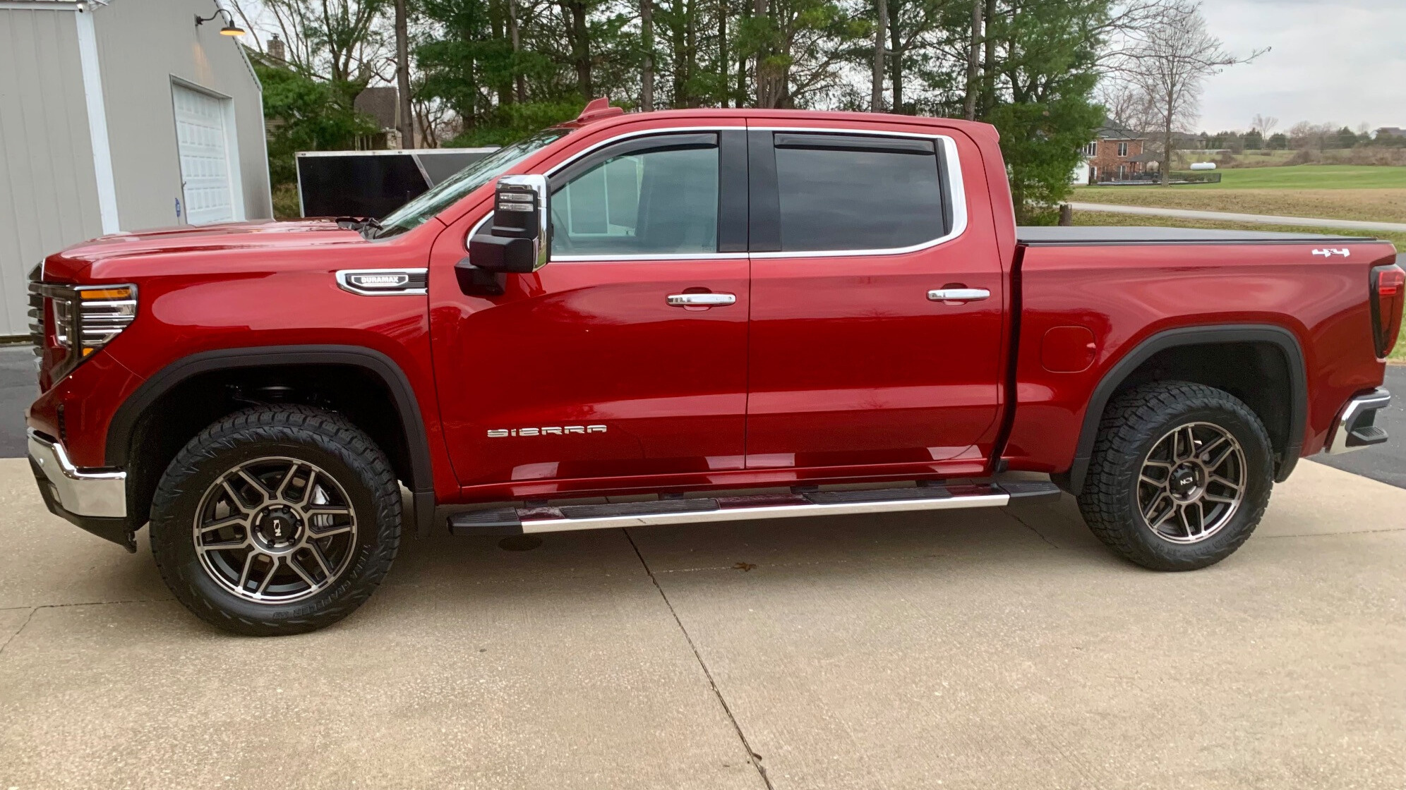 profile view of red truck with nitto terra grappler g3