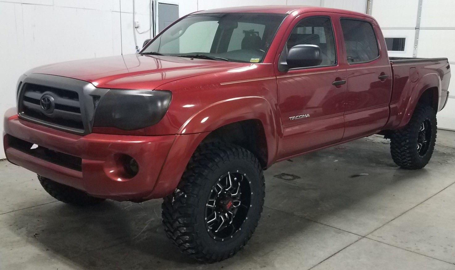 lifted toyota tacoma in garage