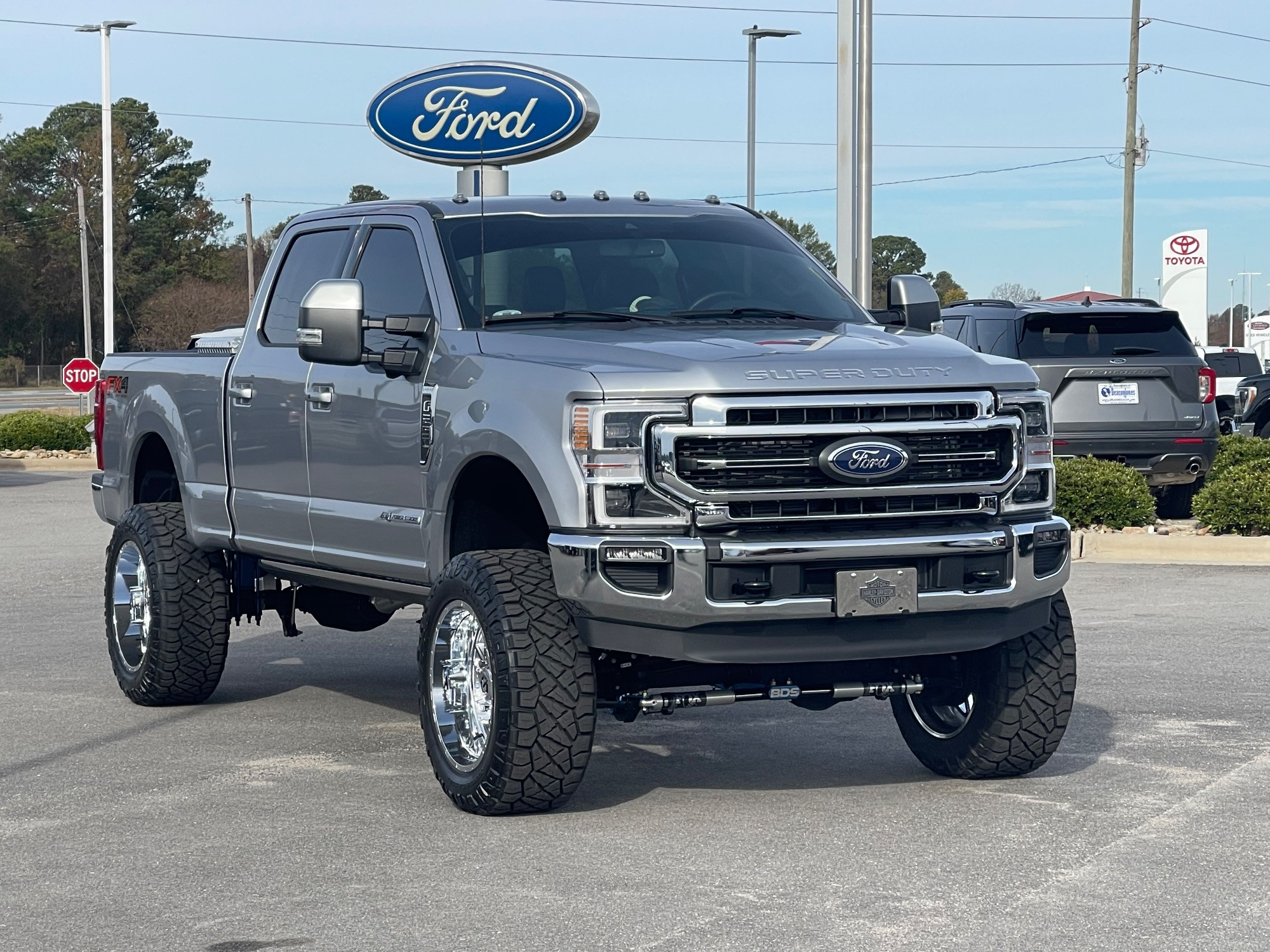 Lifted F-350 dually on aftermarket dually wheels, rear three-quarter view, real owner build