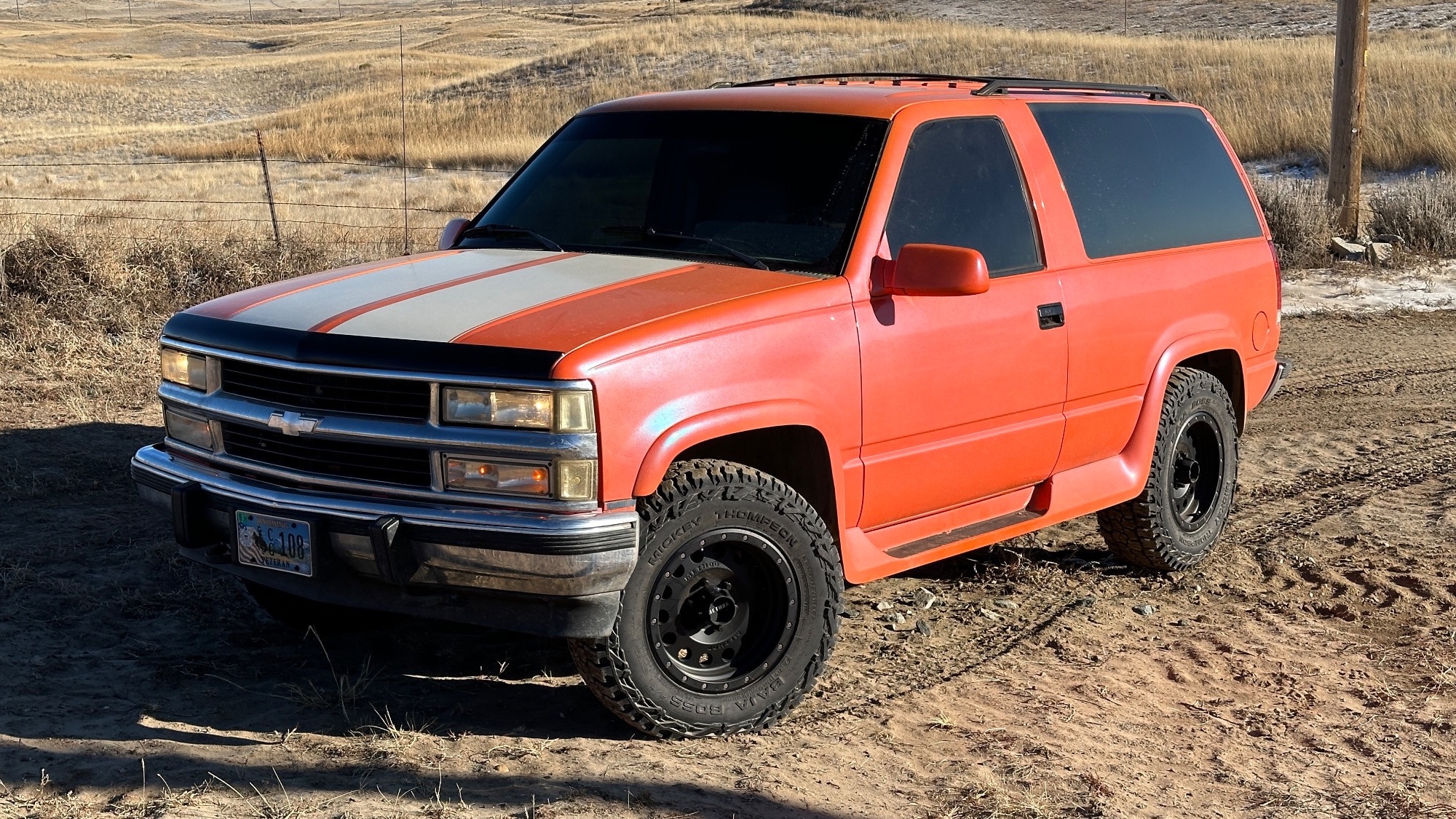 overhead view of red chevy blazer on dirt road
