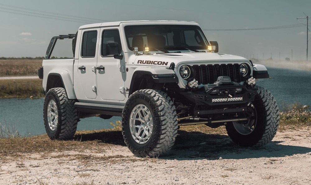 jeep rubicon parked in front of lake