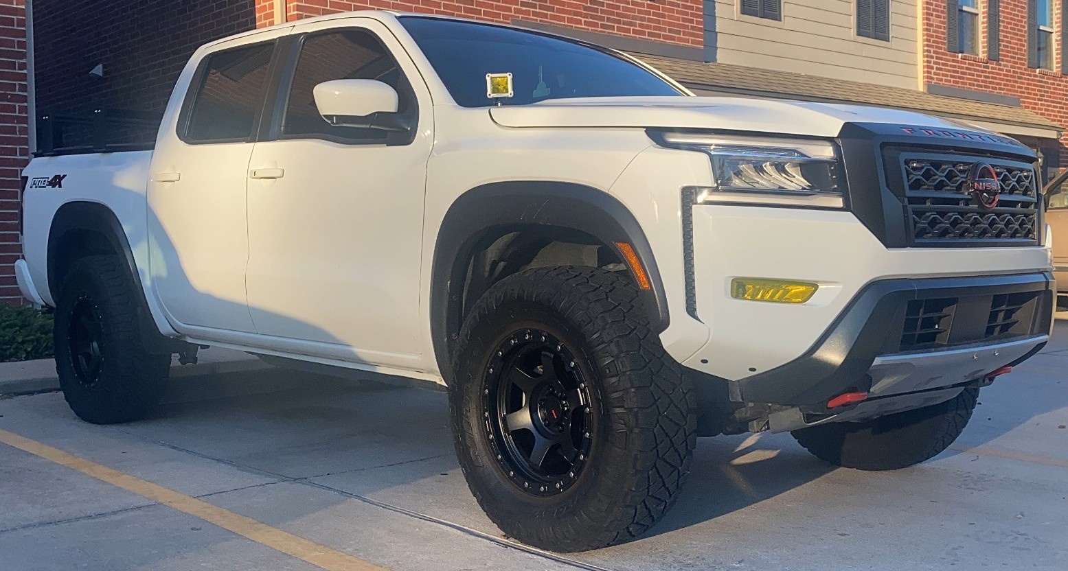 side shot of white nissan frontier pro-4x