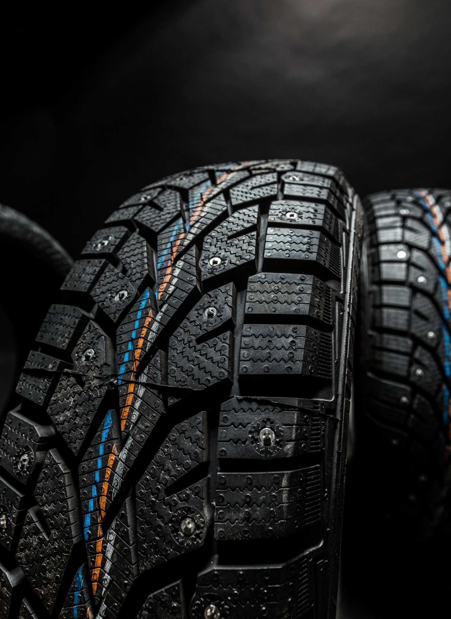 isolated view of winter tire on black background